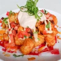 Loaded Tater Tots · Cheddar & jack cheeses, bacon, diced tomato, green onions, chipotle sour cream.