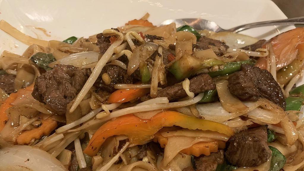 Khee Mao · Spicy stir fried wide noodles with carrots, tomatoes, peppers, pea pods, and onions combined with our special sauce, your choice of meat contains wheat).
