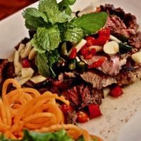 Tiger Cry · Rib-eye steak grilled with fresh garlic, thai chili pepper, lime juice, and fish sauce, serv...