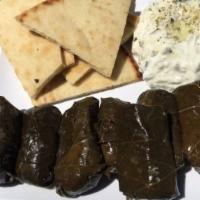 Dolmas · Vegetarian rice mixture wrapped in a grape leaf. Comes with pita bread and tzatziki.