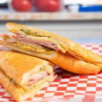 Cubano · Spice rubbed braised pork and ham topped with Swiss, pickles and mustard sauce on griddled F...