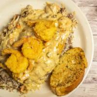 Fried Catfish (2 Strips) W/Opelousas Sauce  · (Cream Sauce w/Crabmeat, Shrimp, Crawfish & Oysters) 
over Dirty Rice w/ Garlic Bread