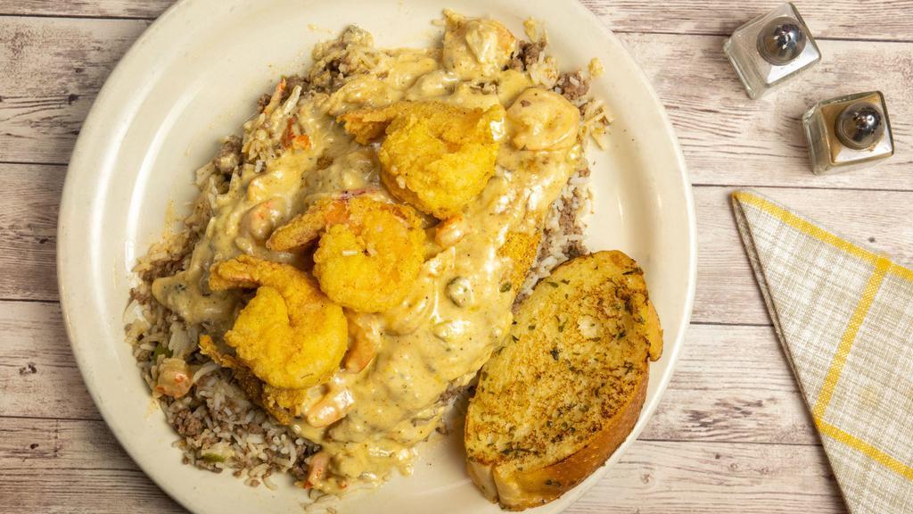 Fried Catfish (2 Strips) W/Opelousas Sauce  · (Cream Sauce w/Crabmeat, Shrimp, Crawfish & Oysters) 
over Dirty Rice w/ Garlic Bread