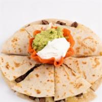 Quesadilla With Fajita · Two extra large tortillas filled with monterrey jack cheese and your choice of fajita meat m...
