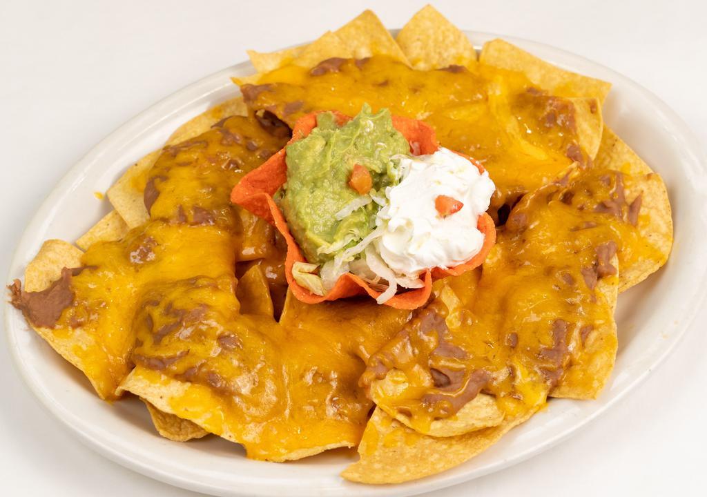 Bean & Cheese Nachos · A platter of chips topped with refried beans and melted cheddar cheese. Now served with guacamole and sour cream