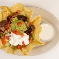 Taco Salad · A bed of Lettuce topped with Your choice of meat, tomatoes, cheddar cheese, monterrey jack c...