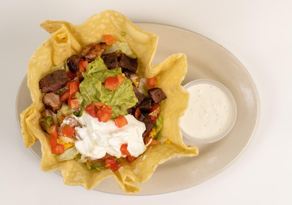 Taco Salad · A bed of Lettuce topped with Your choice of meat, tomatoes, cheddar cheese, monterrey jack cheese, guacamole, and sour cream. Served with ranch dressing