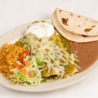 Green Enchilada · Two chicken enchiladas covered in green salsa and topped with melted monterey jack cheese.