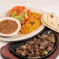 Carne Asada Plate · Lightly seasoned, thinly sliced top sirloin.  Served with lettuce and tomato and a side of g...