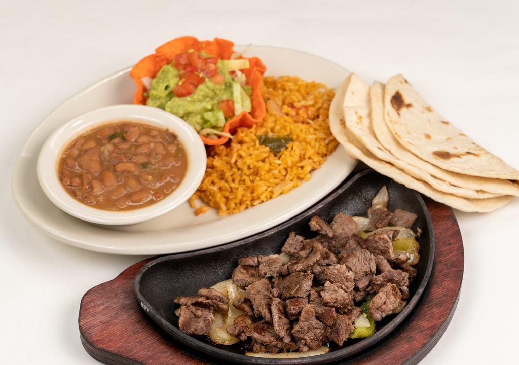 Carne Asada Plate · Lightly seasoned, thinly sliced top sirloin.  Served with lettuce and tomato and a side of guacamole.