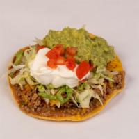 Deluxe Chalupa · Made on a corn tortilla shell with refried beans and your choice of stewed chicken or picadi...