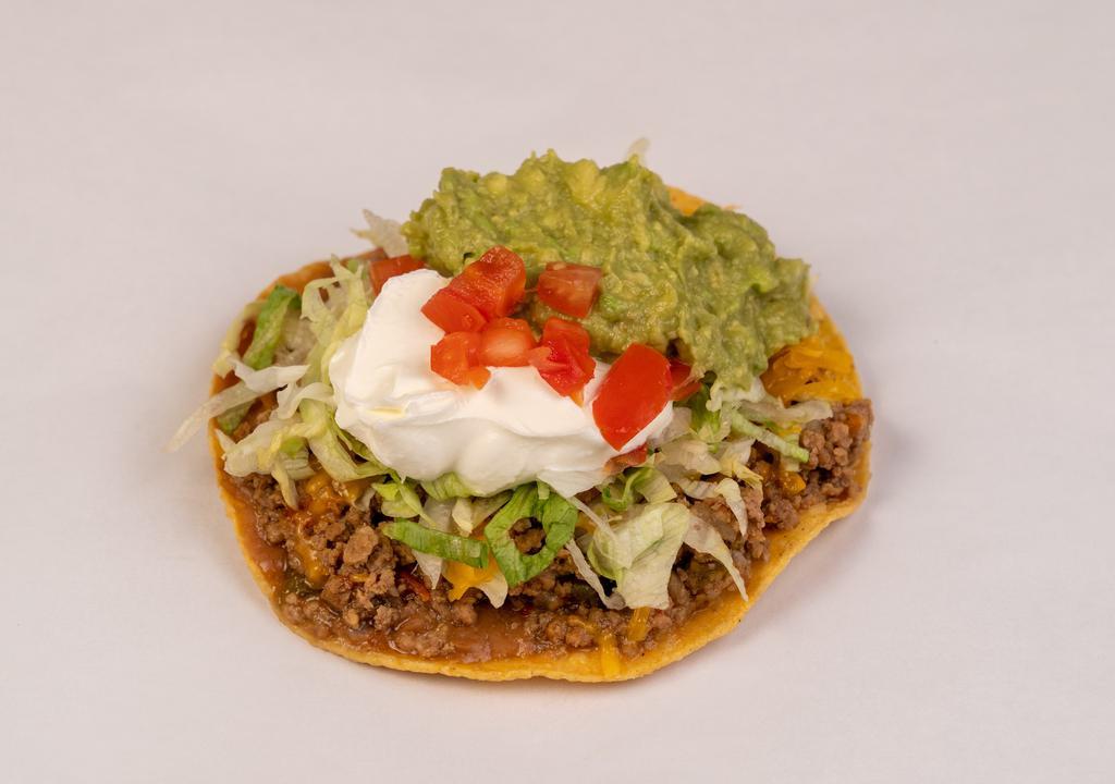 Deluxe Chalupa · Made on a corn tortilla shell with refried beans and your choice of stewed chicken or picadillo meat. Topped with lettuce, cheese, tomato, guacamole, and sour cream.