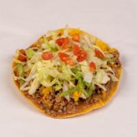 Beef Chalupa · Made on a corn tortilla shell with refried beans and picadillo meat. Topped with lettuce, ch...