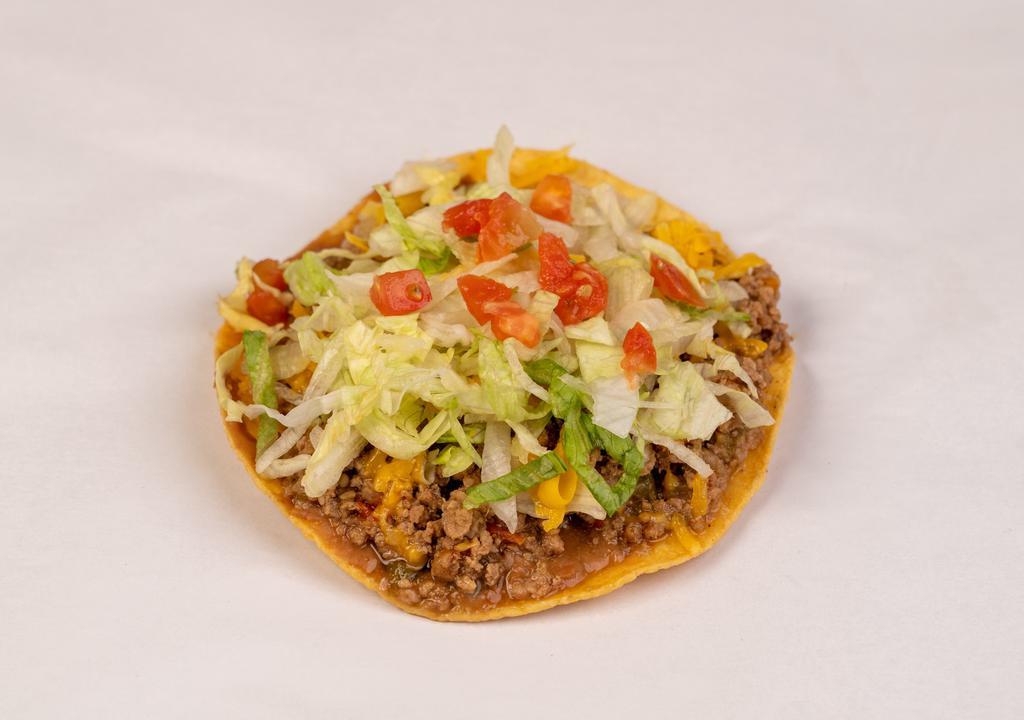 Beef Chalupa · Made on a corn tortilla shell with refried beans and picadillo meat. Topped with lettuce, cheese and tomato.