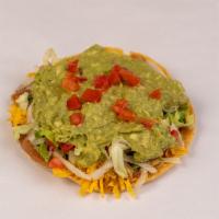 Guacamole Chalupa · Made on a corn tortilla shell with refried beans. Topped with lettuce, cheese, tomato, and f...