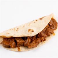 Carne Guisada Taco · A generous portion of carne guisada.