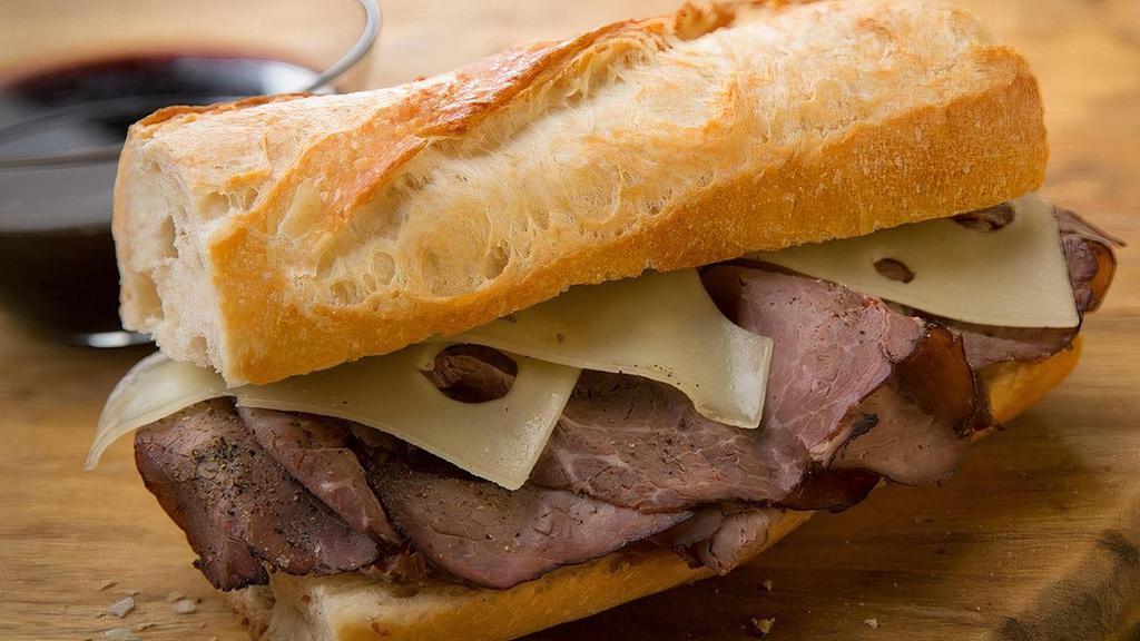 Famous | French Dip · Roast beef, Swiss cheese, au jus, salt & pepper. Served on baguette.