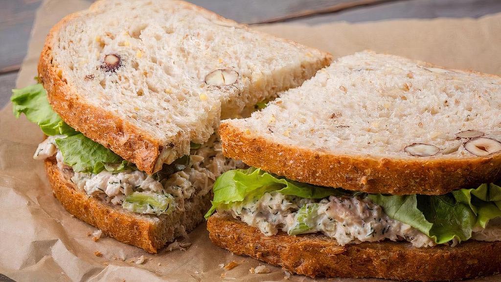 Famous | Tuna · Albacore tuna mixed with dill, red onions, celery, salt & pepper, mayonnaise, lemon juice, and lettuce. Served on hazelnut 12 grain.