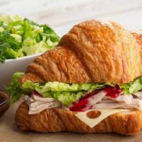 Croissant | Turkey Cranberry Sandwich · Slow-roasted, hand-pulled turkey, cranberry sauce, Swiss cheese, lettuce, salt & pepper. Ser...