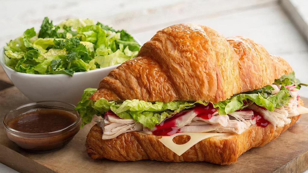 Croissant | Turkey Cranberry Sandwich · Slow-roasted, hand-pulled turkey, cranberry sauce, Swiss cheese, lettuce, salt & pepper. Served with a complimentary side of spring greens and balsamic vinaigrette.