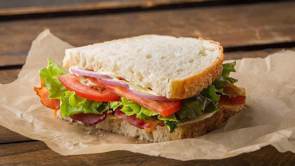 Sandwich | Classic Café Sandwich · Kneaders sauce, provolone cheese, lettuce, tomatoes, red onions, salt & pepper. May be served as a whole or half sandwich on your choice of bread.