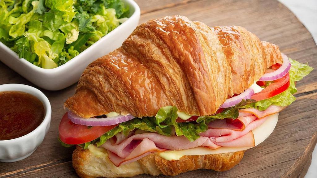 Croissant | Café Sandwich · Kneaders sauce, provolone cheese, lettuce, tomatoes, red onions, salt & pepper on a whole croissant. Served with a complimentary side of spring greens and balsamic vinaigrette.