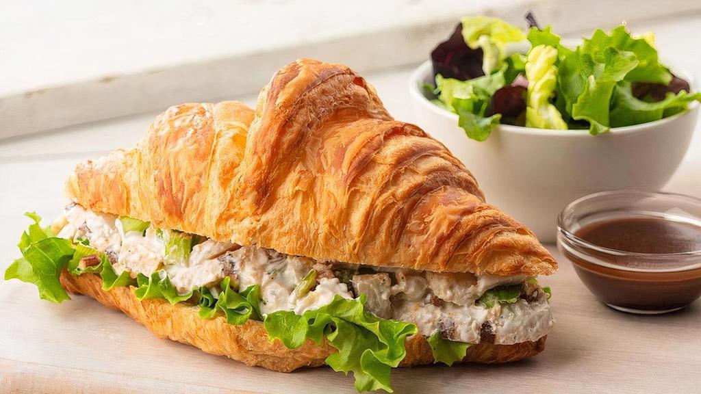 Croissant | Chicken Salad Sandwich · Chunks of grilled chicken breast, water chestnuts, celery, pecans, and green onions, mixed in a sour cream vinegar sauce, served cold. Served with a complimentary side of spring greens and balsamic vinaigrette.