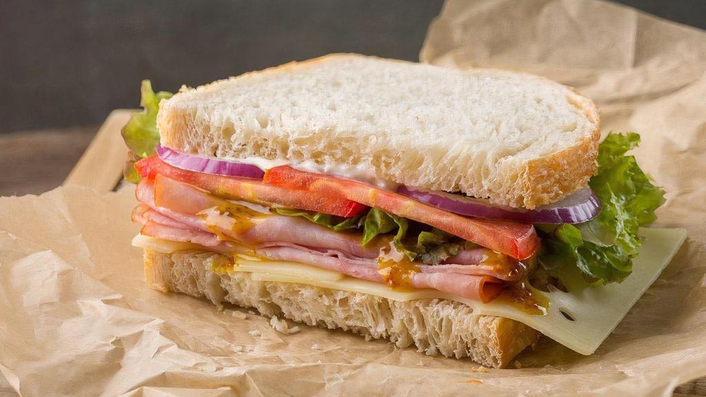 Sandwich | Ham And Swiss Café Sandwich · Honey mustard, mayonnaise, Swiss cheese, lettuce, tomatoes, red onions, salt and pepper. May be served as a whole or half sandwich on your choice of bread.