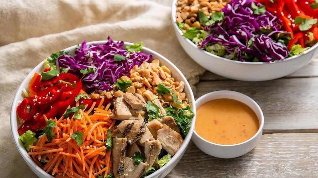 Thai Chicken Salad · Kneaders greens, grilled chicken breast, sliced carrots, red cabbage, red bell peppers, cashews, sesame seeds, fresh cilantro and salt & pepper with spicy Thai dressing on the side.