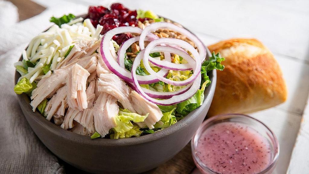 Turkey Cranberry Sunflower Salad · Kneaders greens, slow-roasted, hand-pulled turkey, mozzarella cheese, dried cranberries, sunflower seeds, red onions, salt & pepper with sweet poppy seed dressing on the side. Served with a slice of bread, croutons or roll.