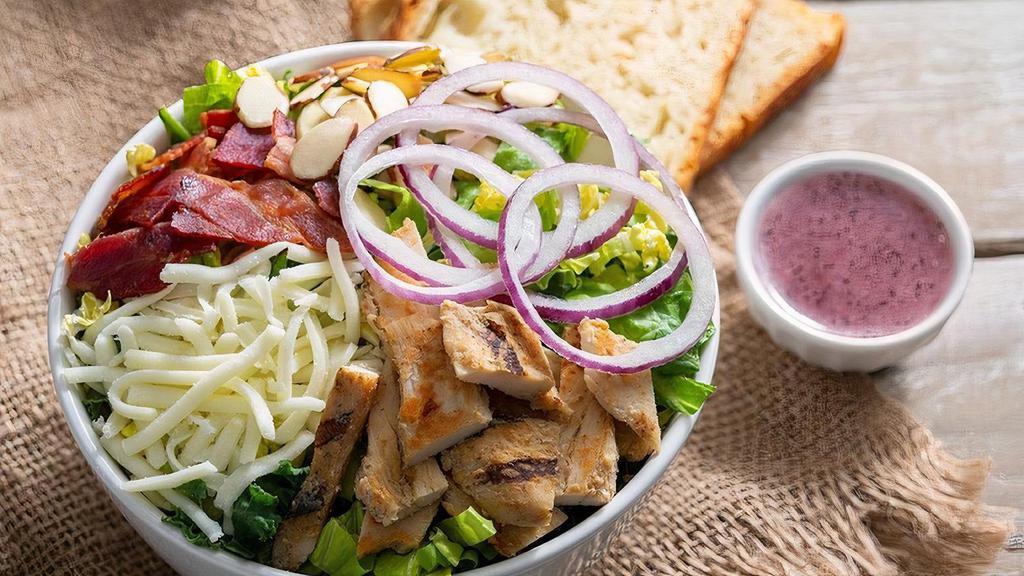 Chicken Ala Mondo · Kneaders greens, grilled chicken breast, crispy bacon, sliced almonds, mozzarella cheese, red onions, salt & pepper with sweet poppy seed dressing on the side. Served with a slice of bread, croutons or roll.