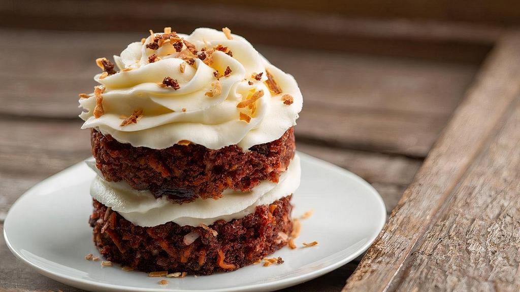 Petite Carrot Cake · Our moist carrot cake loaded with pecans and raisins, decorated with homemade cream cheese icing.