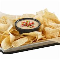 Hatch Queso  · Melted white cheddar, young guns hatch chiles, house-made pico de gallo, house-made tortilla...