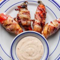Stuffed Jalapeños · Baked bacon wrapped jalapeños stuffed with cream cheese and served with jalapeno ranch.