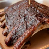 Fall-Off-The-Bone Ribs · Smoked pork baby back, choice of one side.
