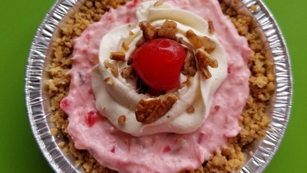 Millionaire Pie · This is a summery treat! It's made with coconut, pineapple, cherries, and pecans in a fluffy whipped base, sat in our classic graham cracker crust, topped with whipped cream, cherries, and chopped pecans!
