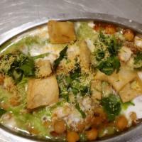 Samosa Chat · Crunchy street delicacy with potatoes and chick peas, flavored with tamarind and mint chutne...