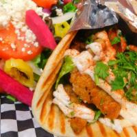 Shawarma Chicken Gyro Sandwich · Served with lettuce, tomato, onions and garlic sauce wrapped in pita bread.