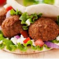 Falafel Gyro Sandwich · Falafel (chickpea fritters) with lettuce, tomatoes, onions, and tahini sauce in a pita.
