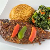 Grilled Tilapia W/ Spinach And  Jollof Rice  · Fresh grilled tilapia seasoned to perfection with sautéed spinach and jollof rice slow-cooke...