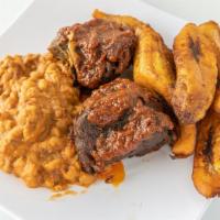 Stewed Goat Meat  W/ Honey Beans & Plantain · Succulent stewed goat meat paired with velvety smooth honey beans and sweet ripe plantains.