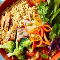 Chicken Bowl · Grilled chicken, quinoa, hummus, spring mix, grated carrots, purple cabbage served in a bowl.