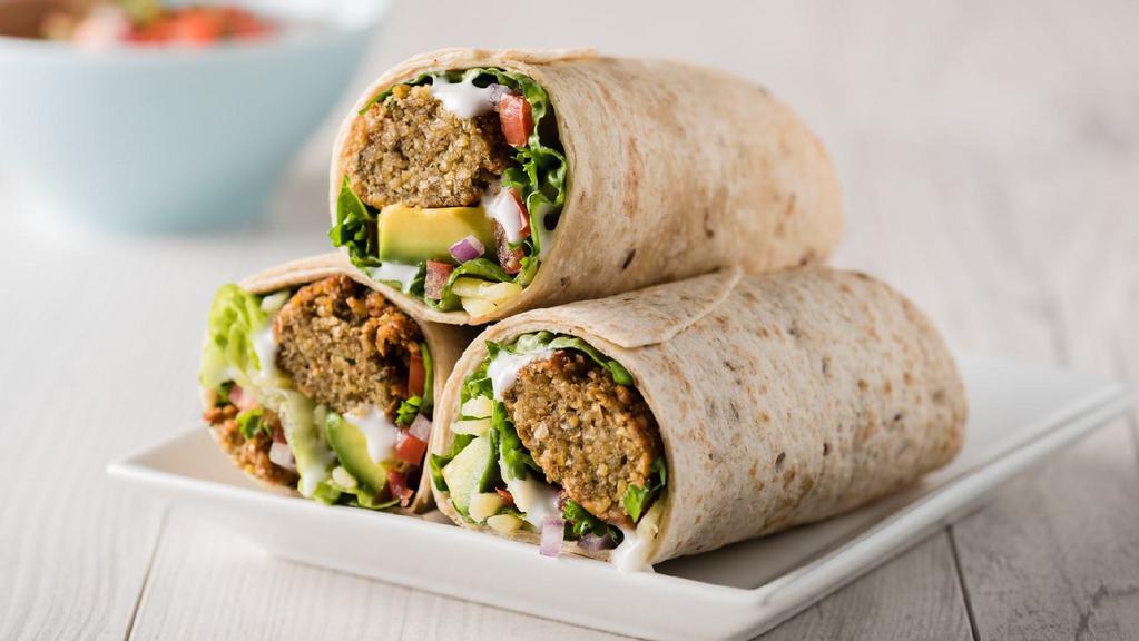 Falafel Wrap · Fried falafel, hummus, jocoque, quinoa, grated carrots, and purple cabbage wrapped in a pita bread. Includes one free side.