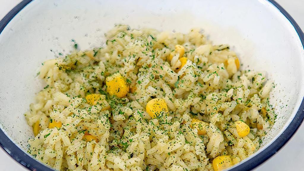 Cilantro Rice · Cooked in a cilantro based mixed with whole corn.