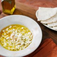 Crumbled Feta Appetizer · crumbled feta cheese topped with dried oregano, zaatar and extra virgin olive oil. Served wi...