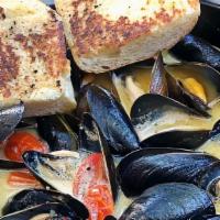 Cast Iron Mussels · Steamed Prince Edward Island Mussels | Garlic | Parsley | Butter Pan Fried Bread  | Choice o...