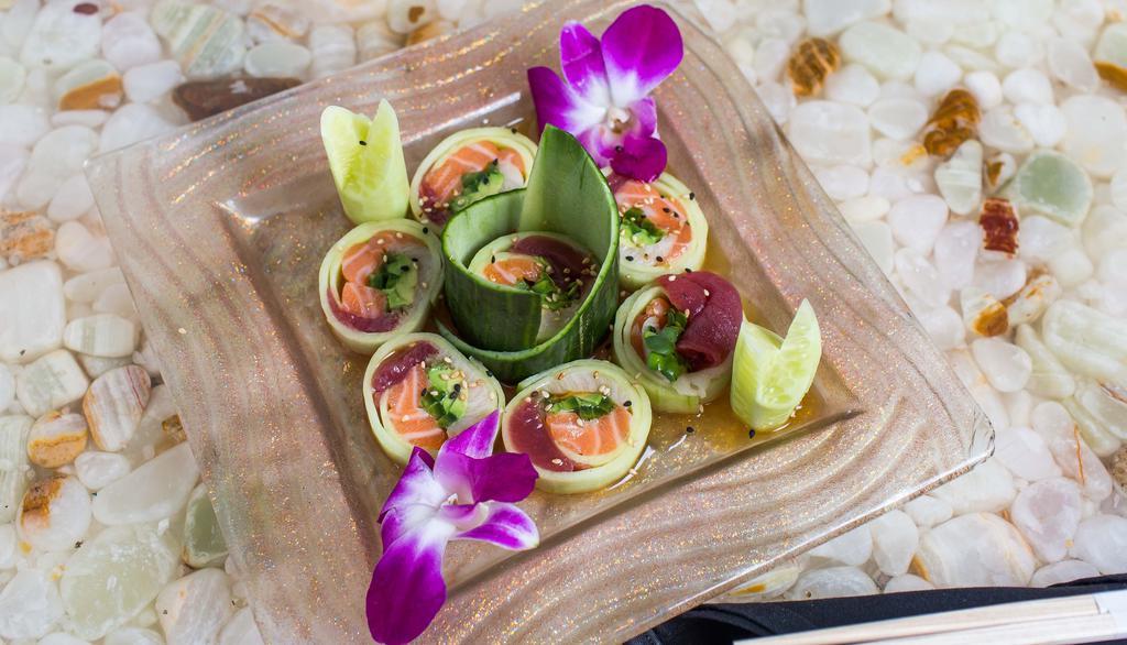 Cherry Blossom (6) · Fresh salmon, tuna, yellowtail, avocado, spicy sprouts & jalapeno rolled in a thin cucumber sheet; served on a bed of ponzu sauce & topped w/ sesame seeds.