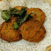Fish Cakes  · Fresh ground snapper mixed with red curry paste, bean and Kaffir lime leaves, served with cu...