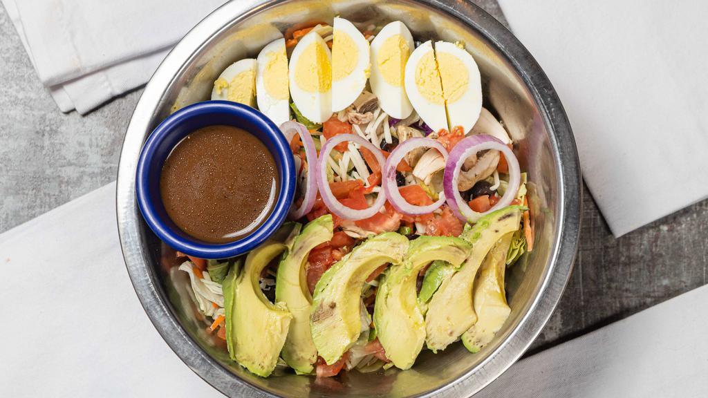 Forest Floor Salad · Cold crisp greens with tomatoes, red onions, black olives, mushrooms, diced hard boiled eggs, avocado slices, and Mozzarella cheese.