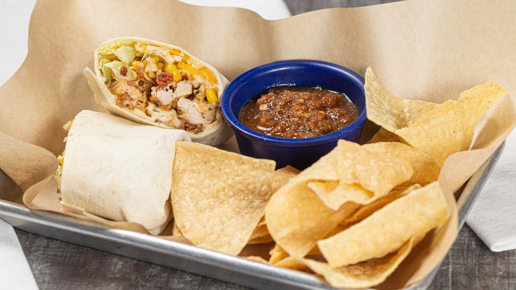 Southwest Chicken Wrap · Grilled chicken, shredded lettuce, shredded cheese, corn pico-de-gallo, bacon bits, crispy tortilla strips all wrapped up in a queso-smeared toasted flour tortilla.  Served with chips & salsa